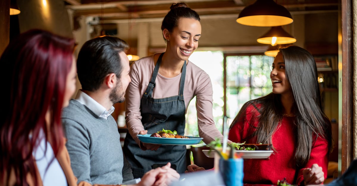 Waitress serving customers their lunch in a restaurant