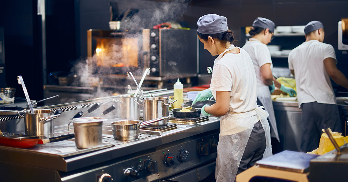 Chefs and cooks working in a dark kitchen