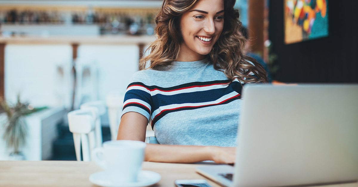 Hospitality worker completing an online course on her laptop in a cafe