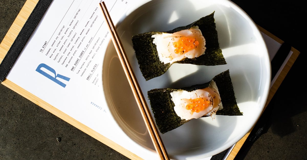 Sushi on a plate with a RND menu sitting under the plate