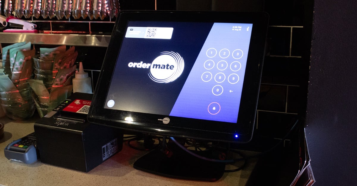 An image of OrderMate POS System and printer located in a restaurant