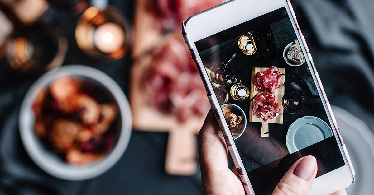 Taking a photo of your food in a restaurant