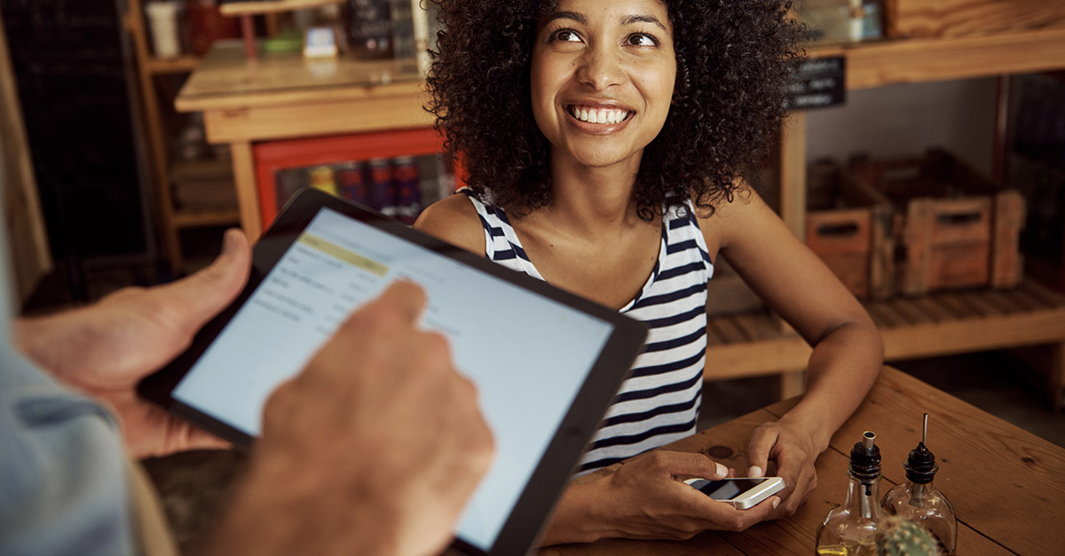 Wait staff serving woman with tablet POS