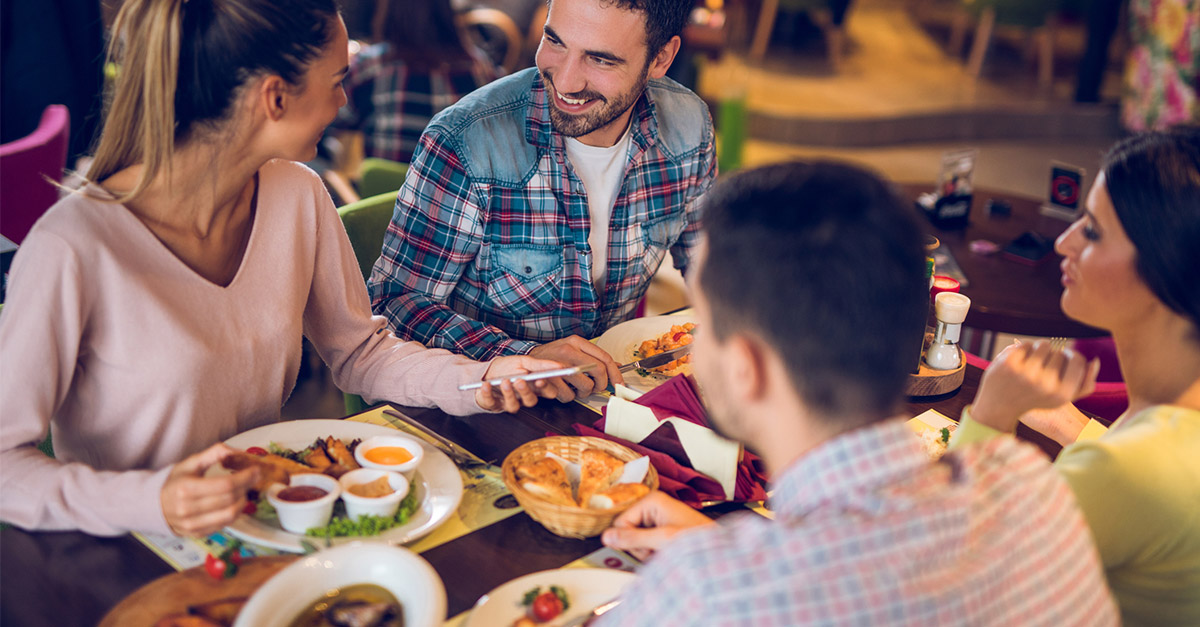 Group of people enjoying a meal at a restaurant 