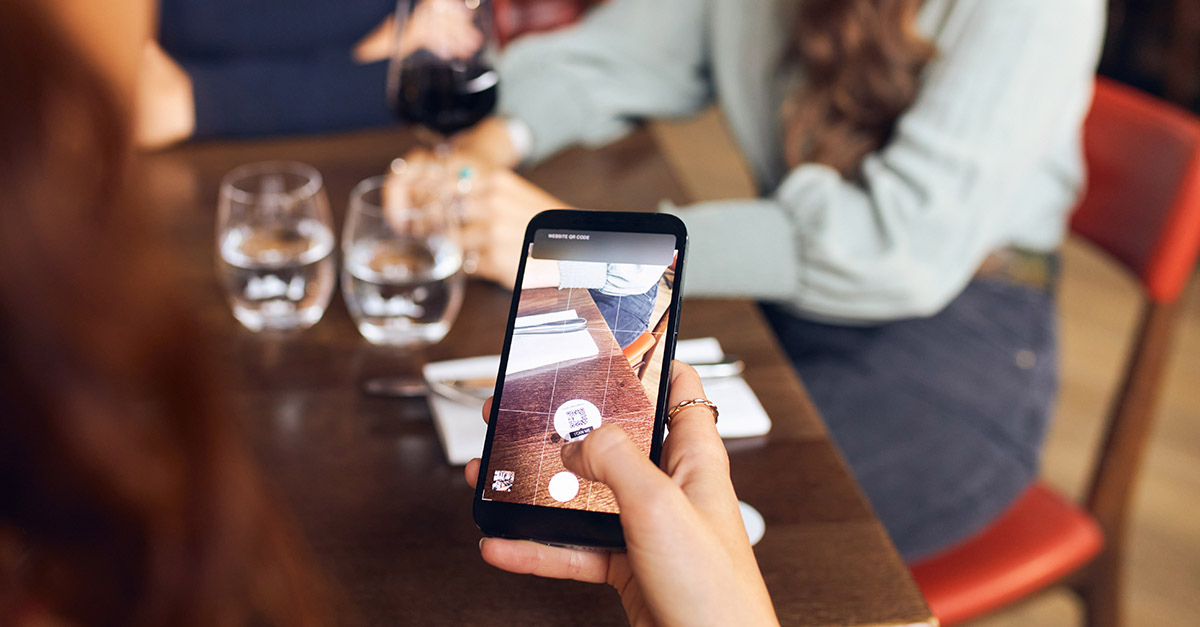 Customer scanning a QR code to order at-table in a restaurant