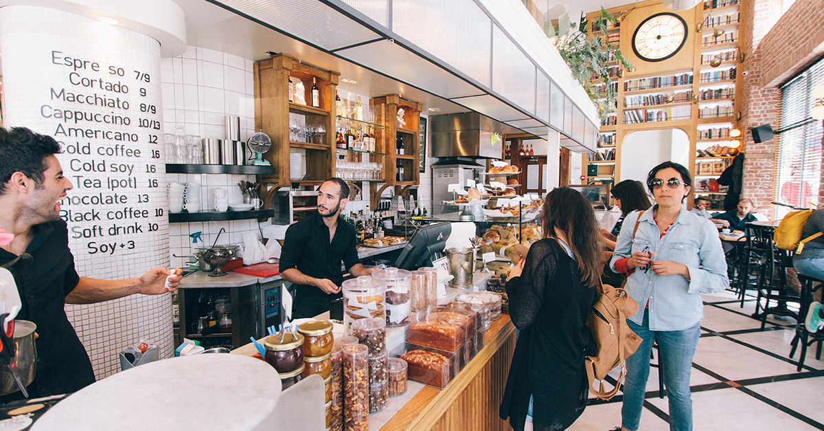 hospitality staff serving customers in a cafe