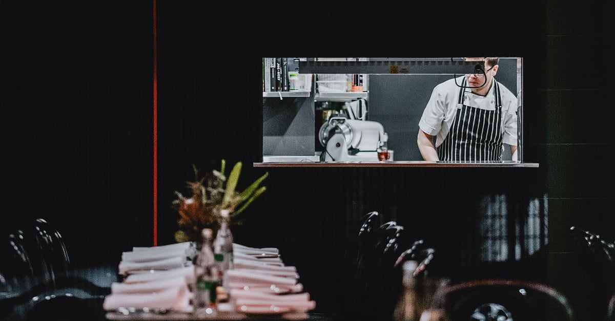 restaurant interior, chef cooking in kitchen