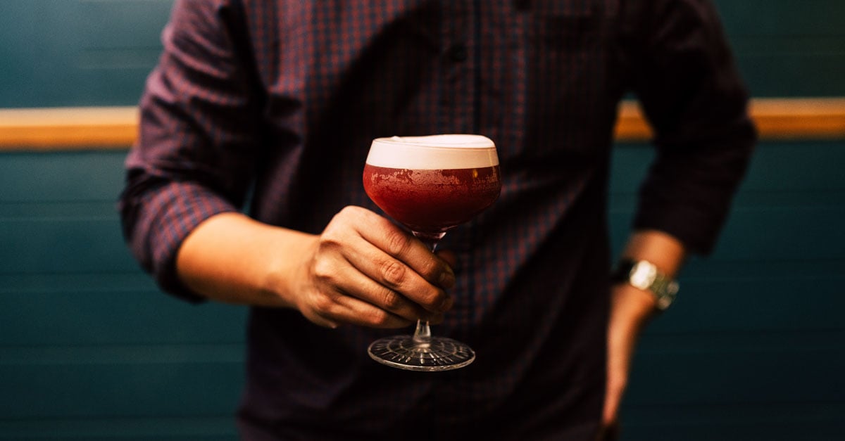 Waiter holding cocktail