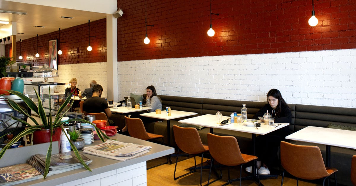 Customers sitting in cafe enjoying coffee