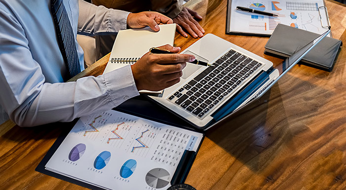 multi-site management laptop on desk