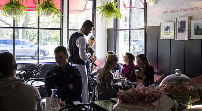 Waiter serving tables in a restaurant