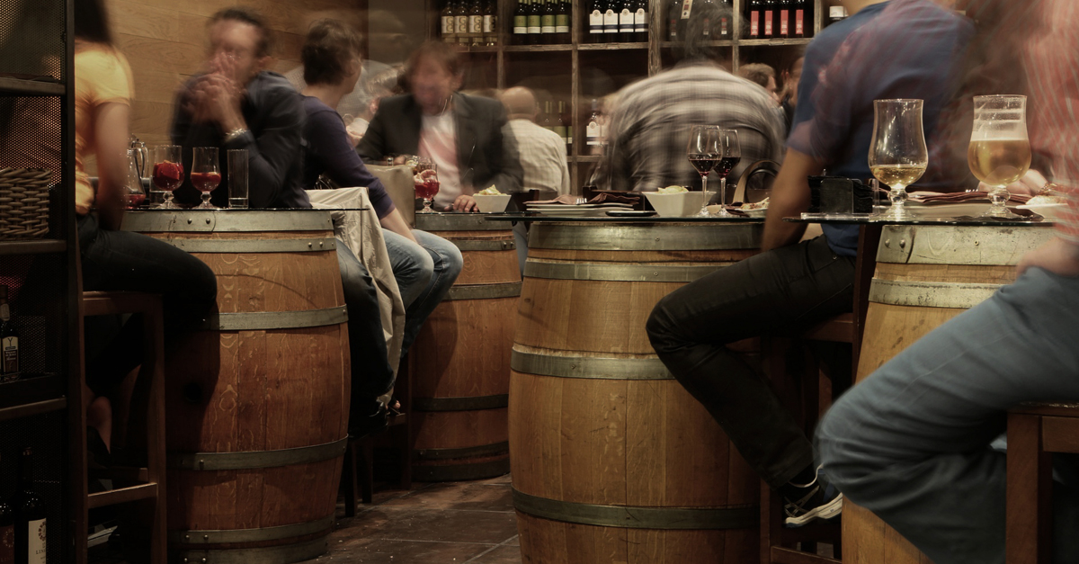 Customers dining in a venue at bar tables