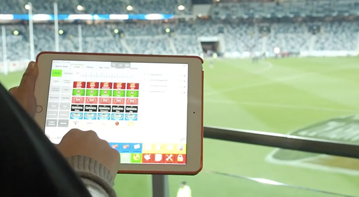 Waiter taking an order on tablet POS in the stadium