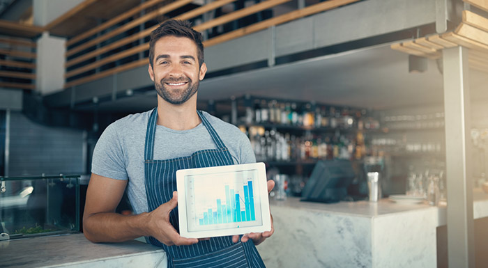 Manager with tablet showing sales data