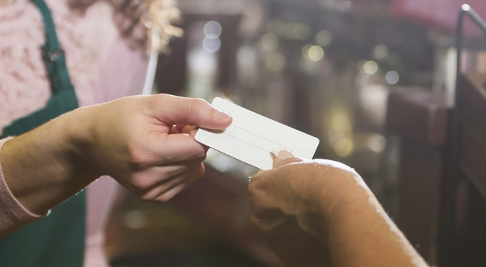 Customer handing card over counter