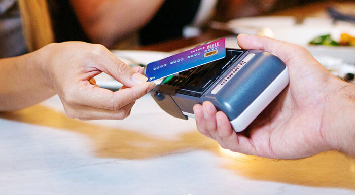 Customer paying by card tap at table