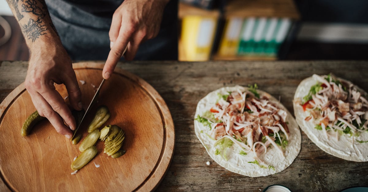 chef cutting pickles for tacos