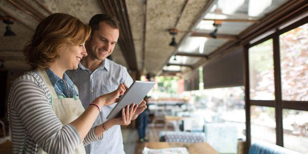 restaurant staff looking at tablet