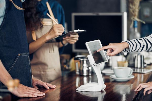 restaurant staff member using tablet pos