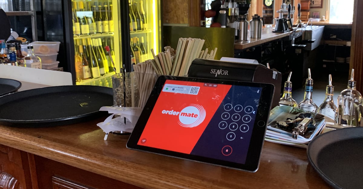 OrderMate POS tablet sitting on a bar