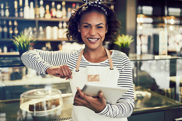 A restaurant staff member using a POS tablet