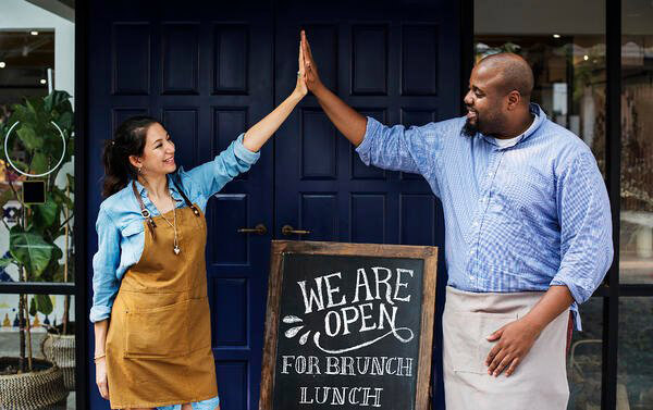 restaurant staff high five when opening up