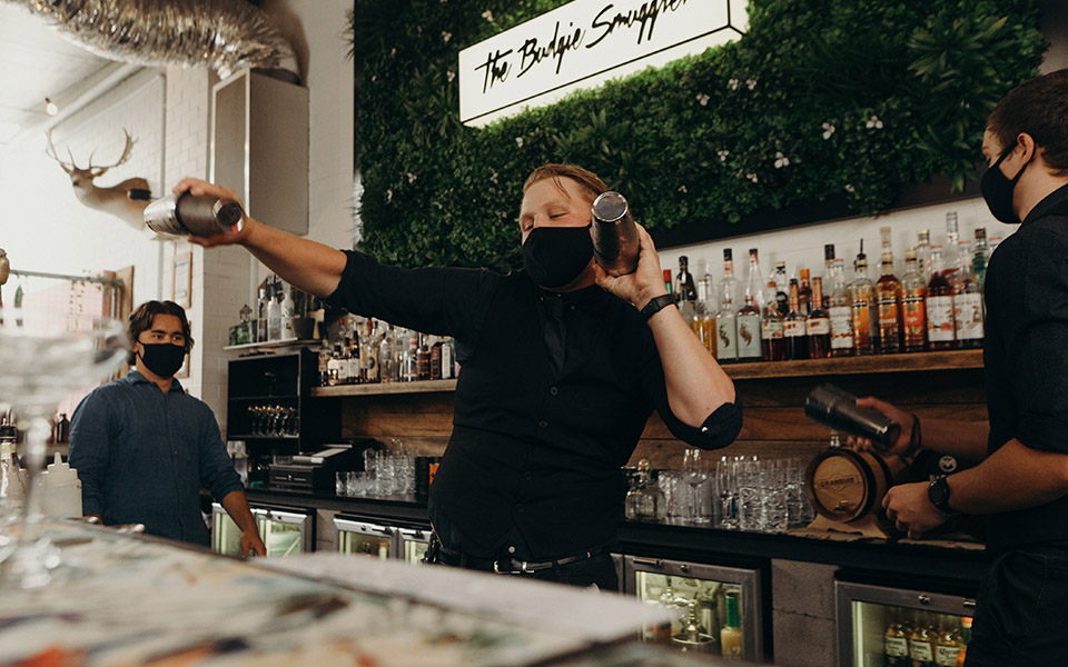 Bar tender mixing drinks behind the bar