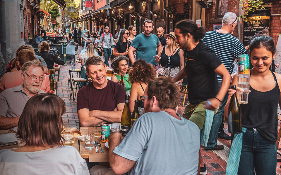 Busy Melbourne laneway with people dining enjoying food and drink