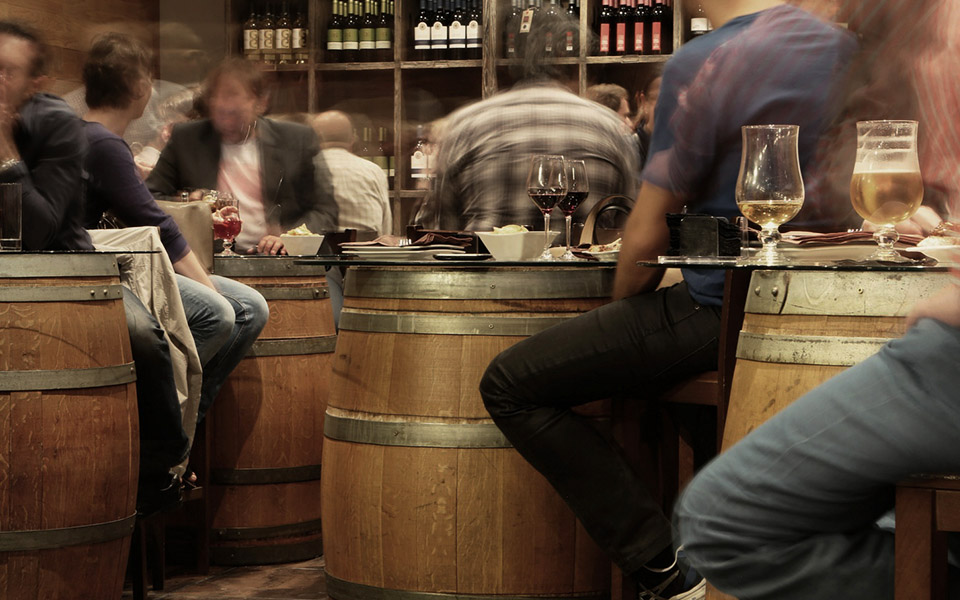 Diners in a winery cellar door enjoying wine and food